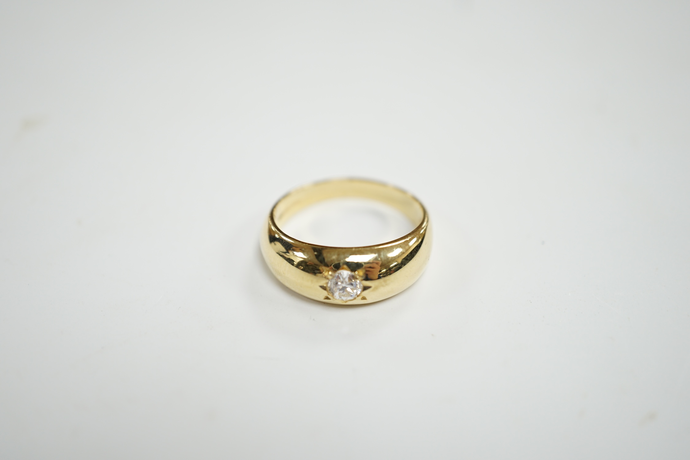 An 18ct gold and gypsy set solitaire diamond ring, size Q, gross weight 6.7 grams.